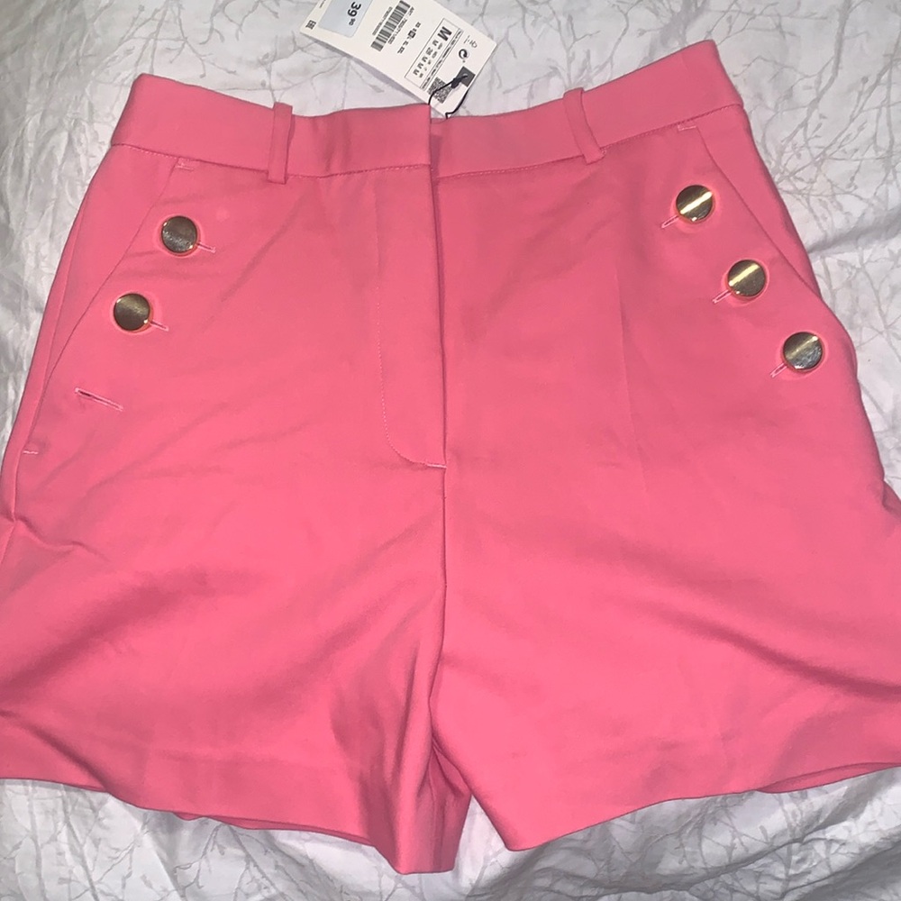 medium size classy shorts with gold buttons, open buttons to use pockets.